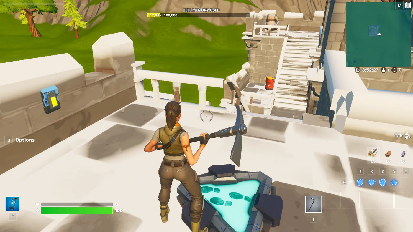 A player standing between a Button device and an Explosive device.